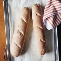 baguette loaves on baking sheet