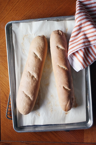 baguette loaves on baking sheet