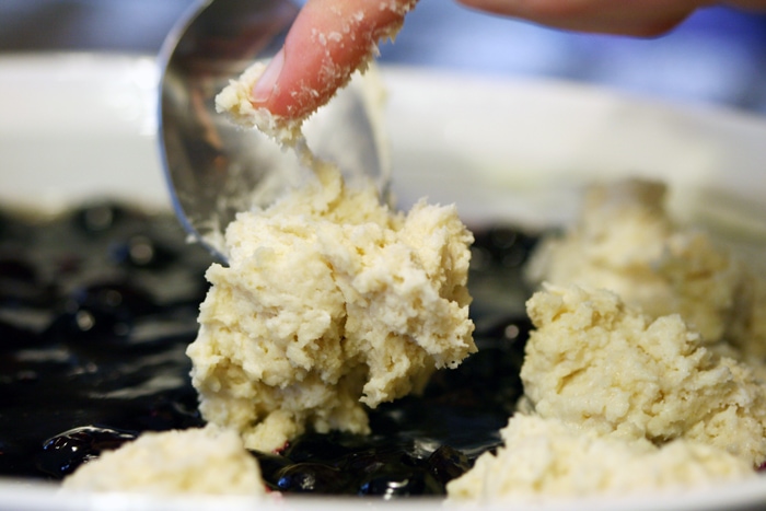 preparing cobbler in baking dish