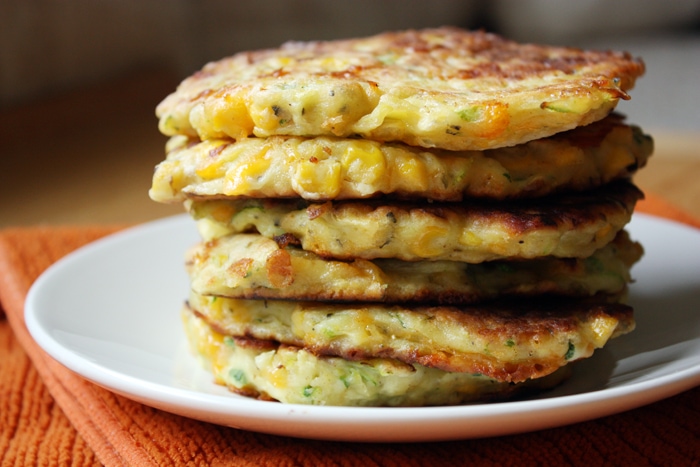 stack of zucchini corn pancakes on a plate