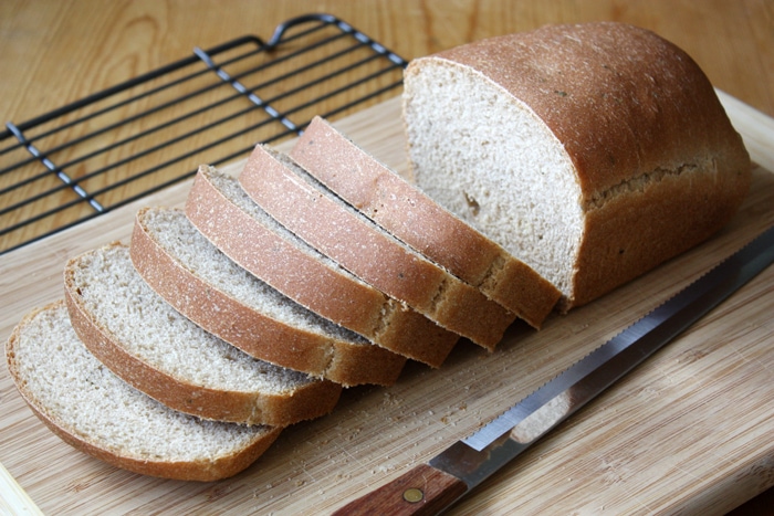 ricotta olive oil herb bread sliced on cutting board