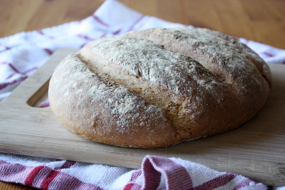 crockpot peasant bread on cutting board