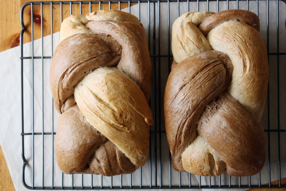 braided rye bread loaves on cooling rack
