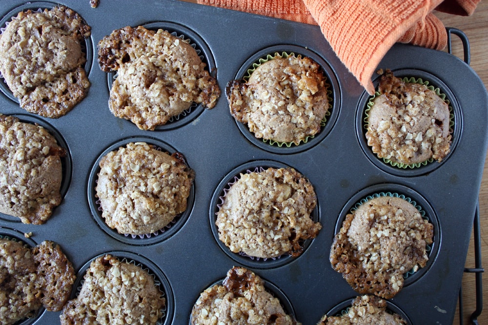 baked caramel pear muffins in muffin pan