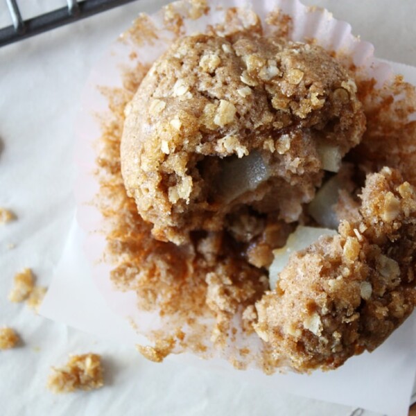 overhead view of caramel pear muffin on parchment paper.