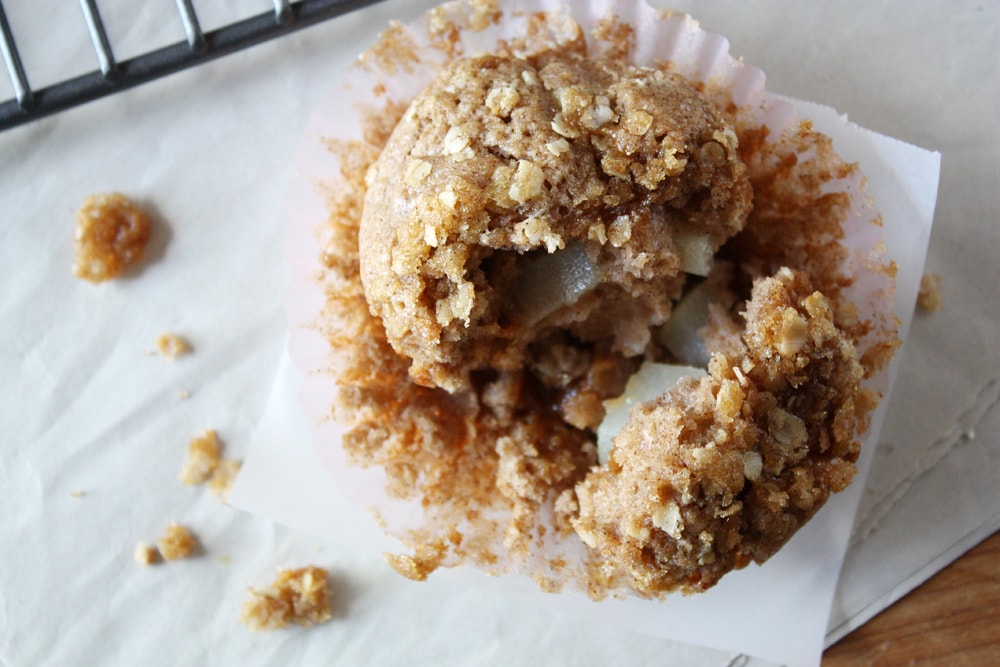 overhead view of caramel pear muffin on parchment paper