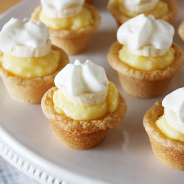 mini banana cream cookie pies on cake stand.