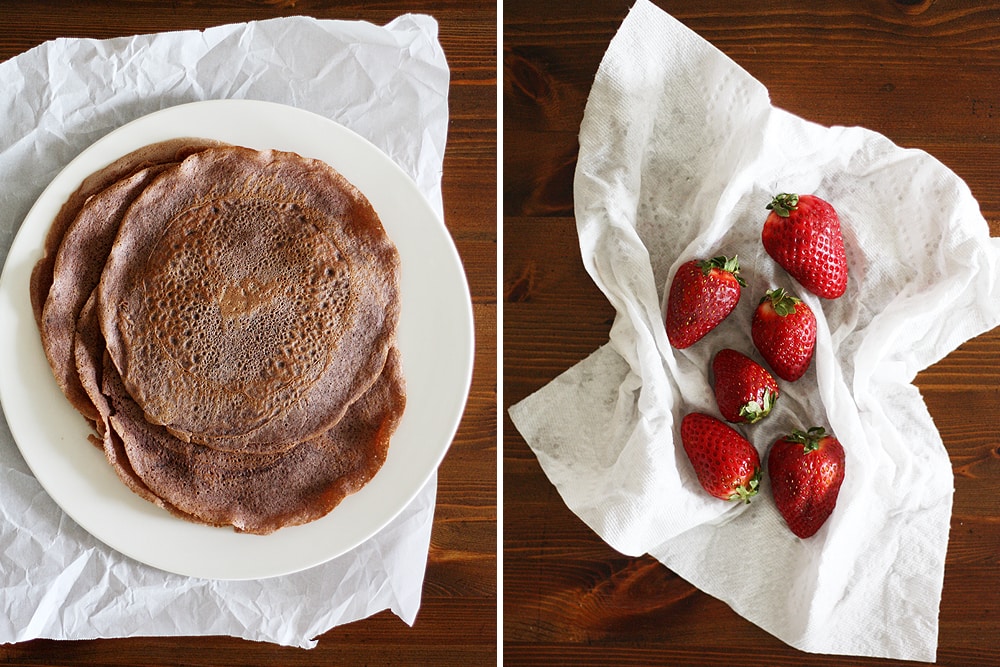 finished chocolate crepes on a plate and strawberries