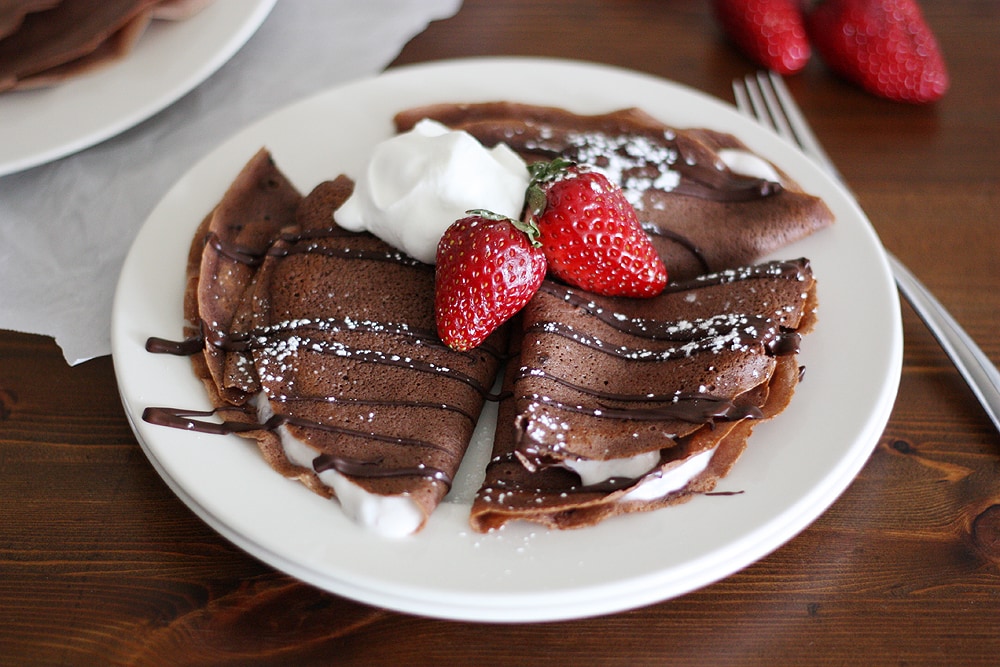 dark chocolate crepes with strawberry yogurt on a plate