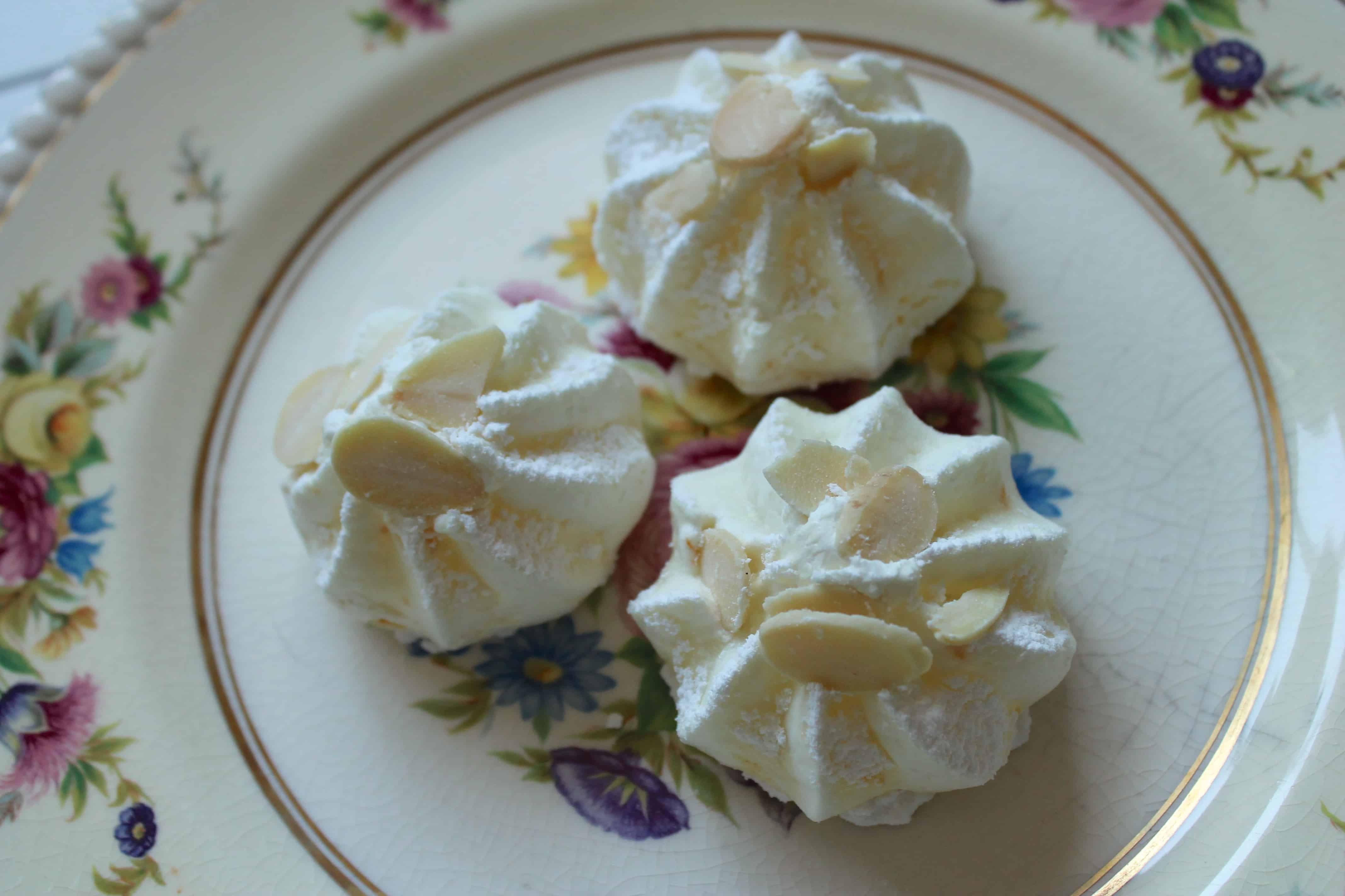 orange almond meringues on a plate