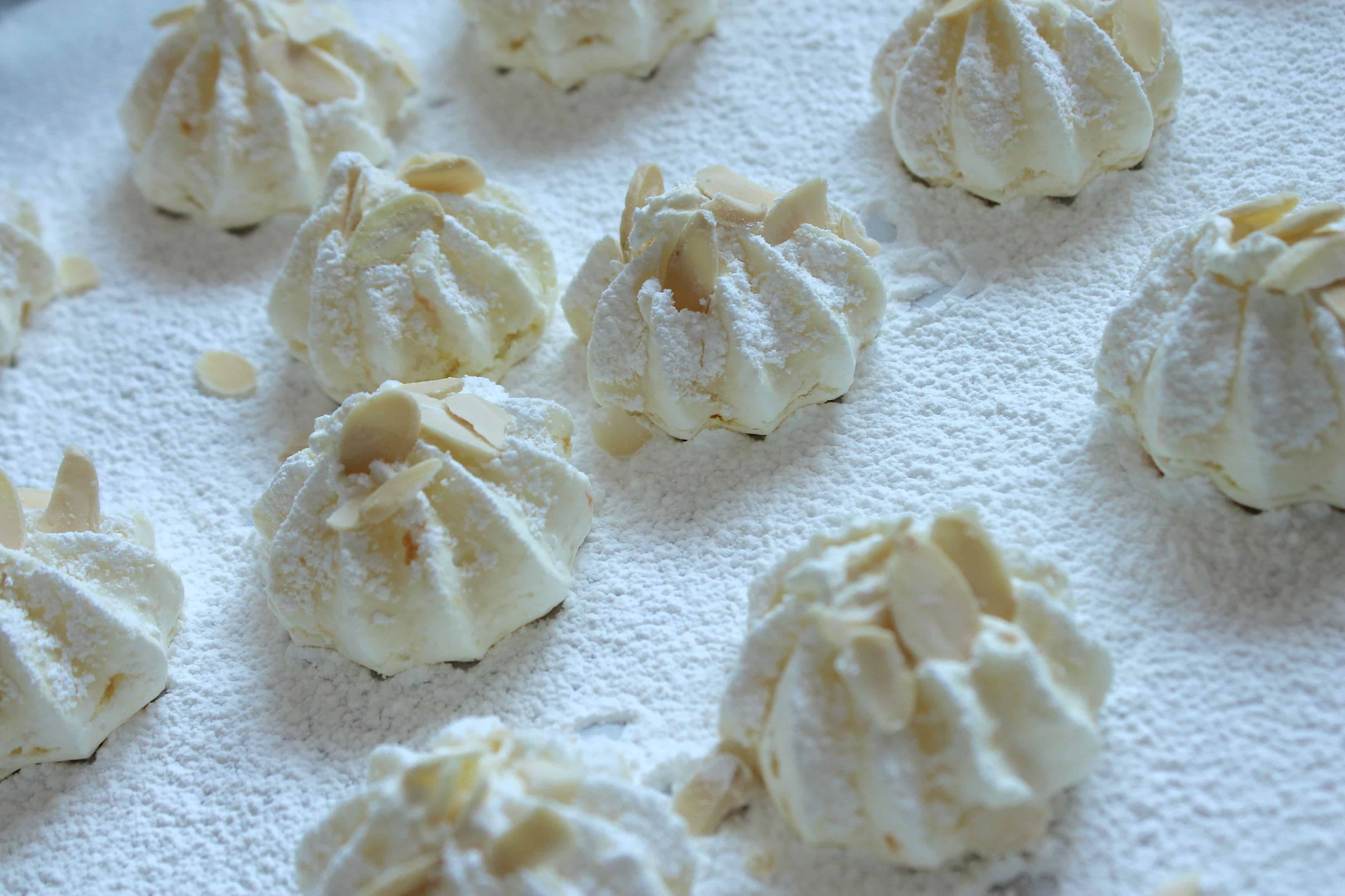 orange almond meringues on parchment paper