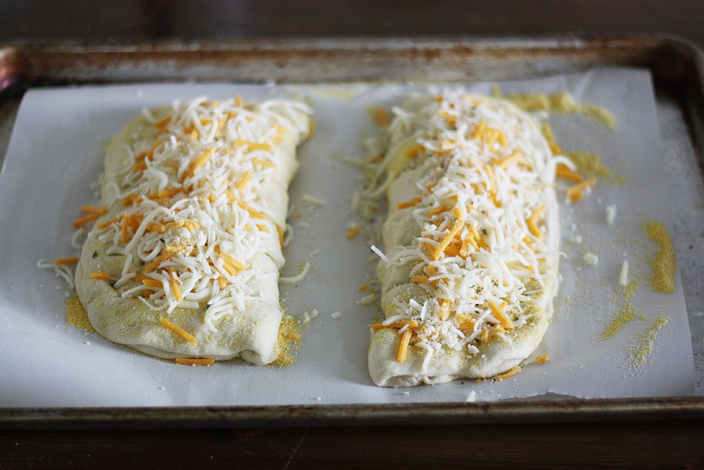 adding cheese on top of bread dough