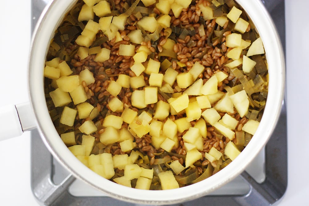 ingredients for autumn harvest spelt pilaf in pot on stove