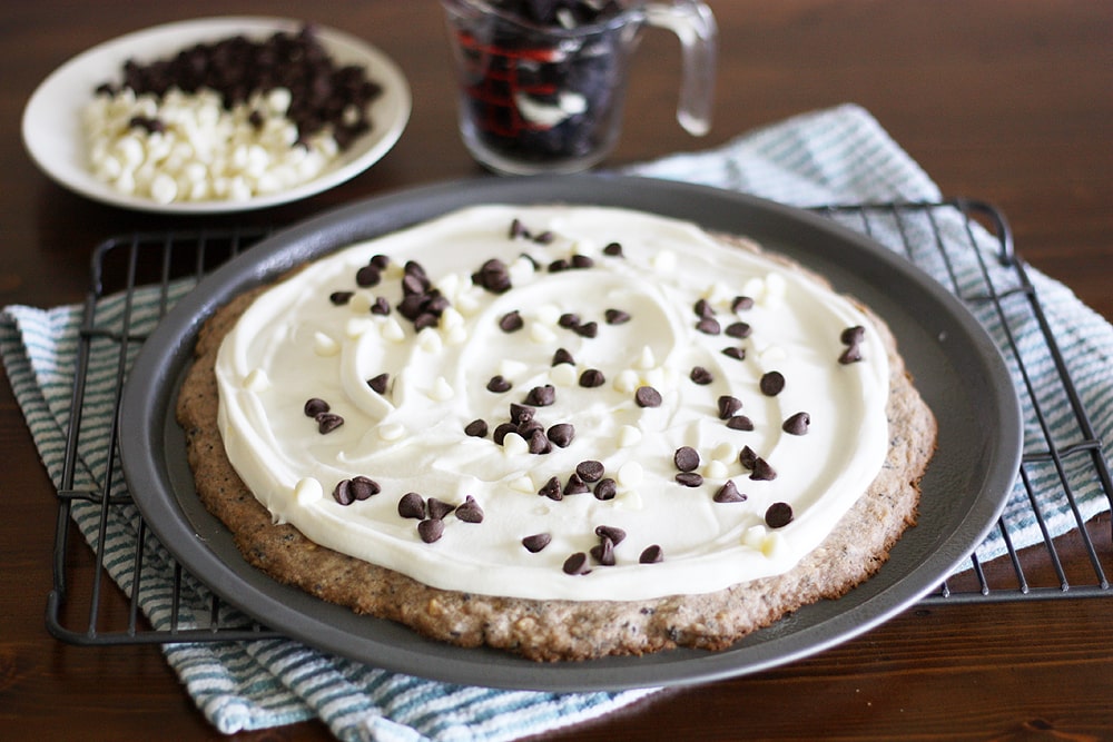 putting chocolate chips on dessert pizza