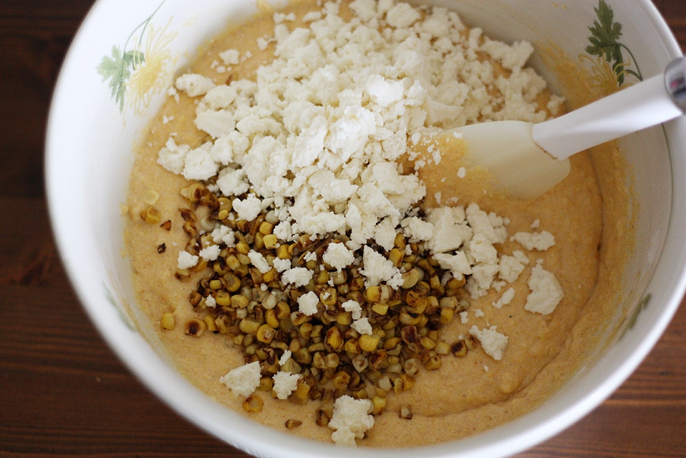 mixing ingredients to make mexican skillet cornbread in bowl