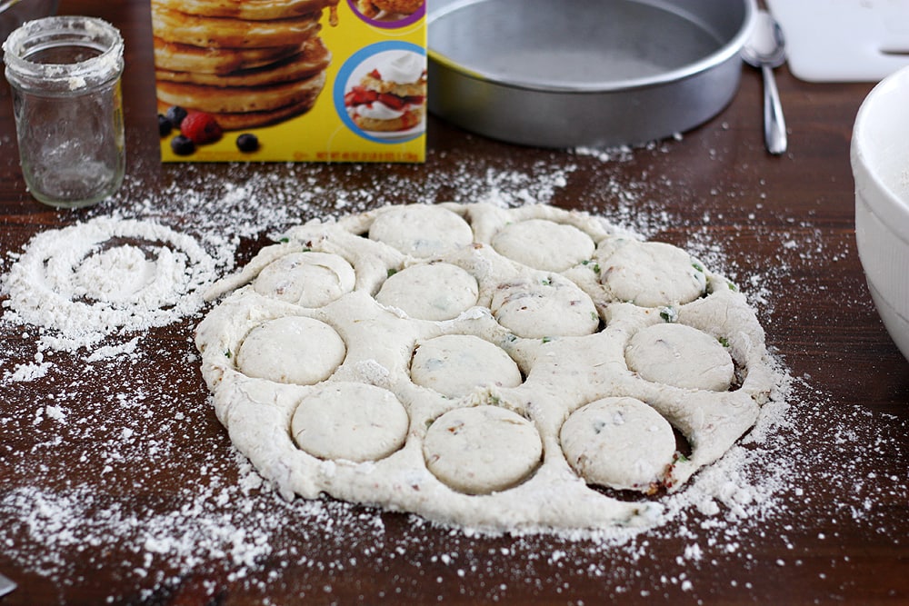 cutting biscuits from dough on table