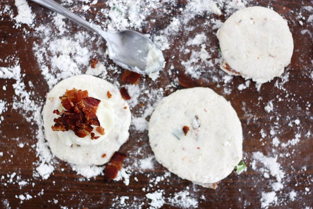 placing bacon in loaded mashed potato biscuit