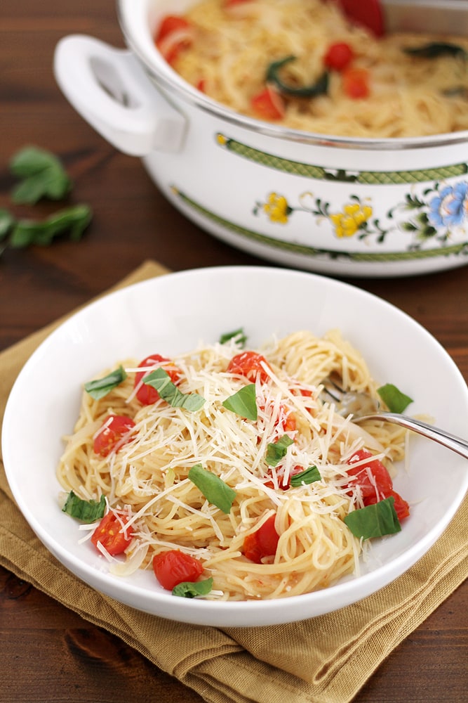 pasta with tomatoes and basil in a bowl