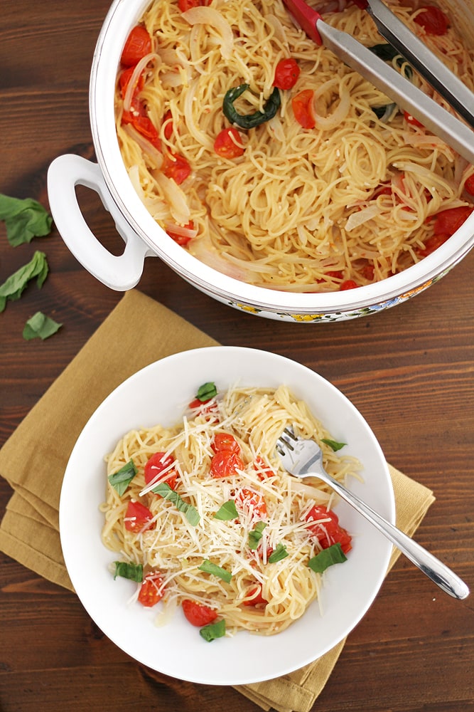 bowl of pasta next to pot on table