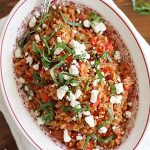 farro with tomatoes and feta in dish.