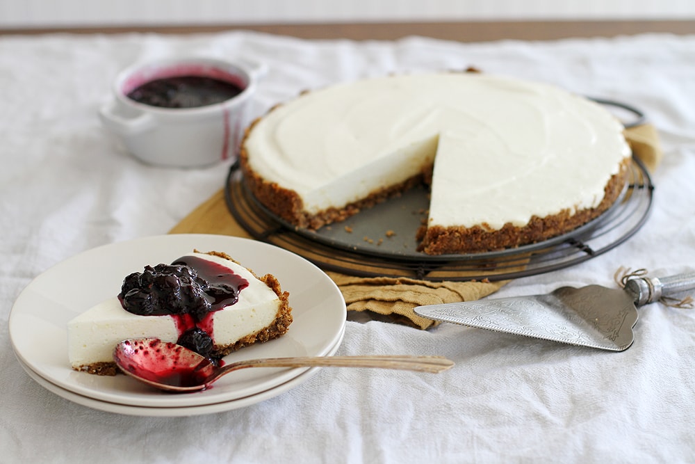 lemon ginger panna cotta cheesecake with slice on plate