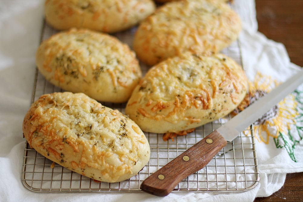 asiago herb hoagie rolls on cooling rack