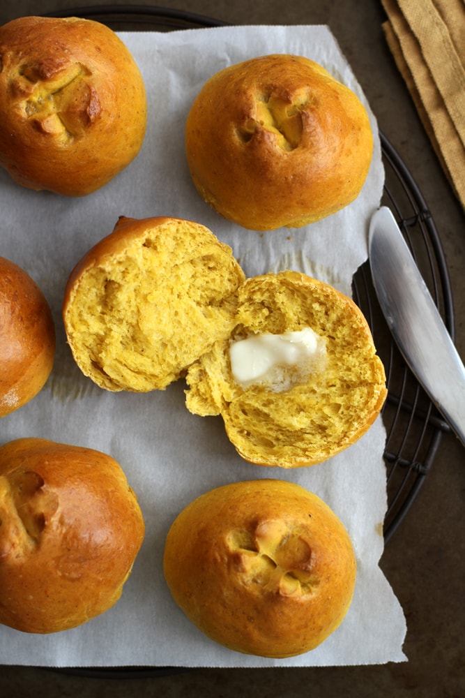 sliced pumpkin brioche roll with pat of butter