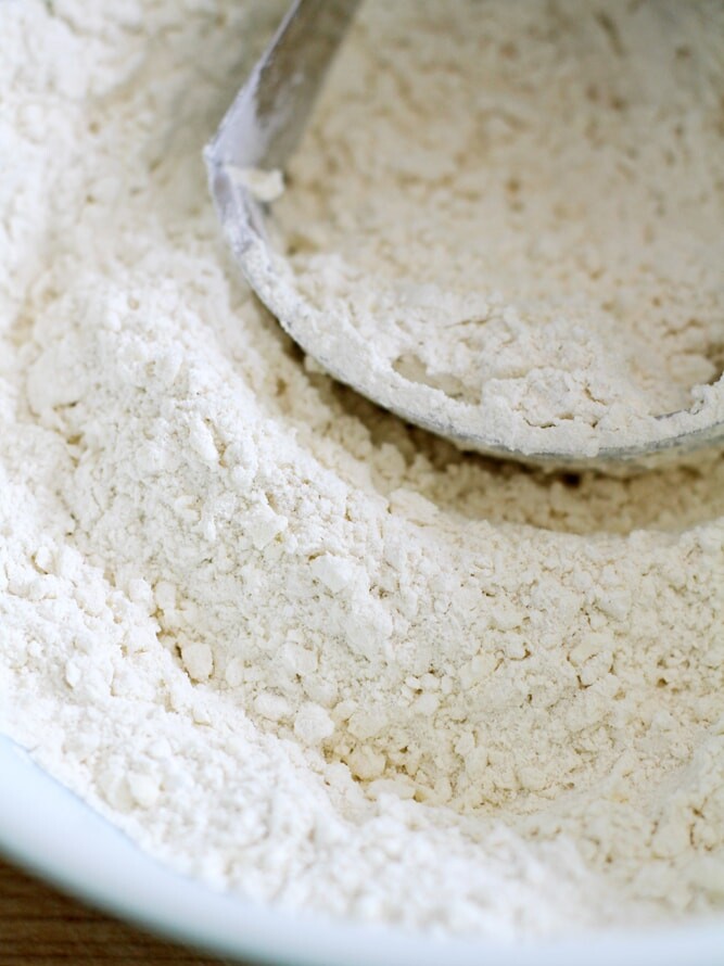 cutting butter into flour in bowl.