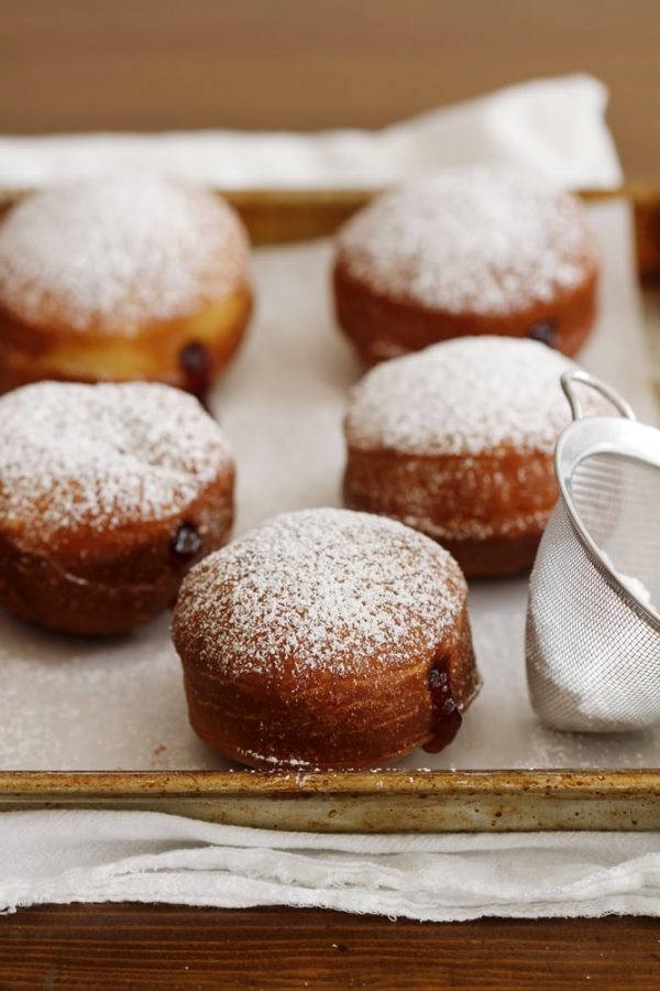 brioche donuts on baking sheet.