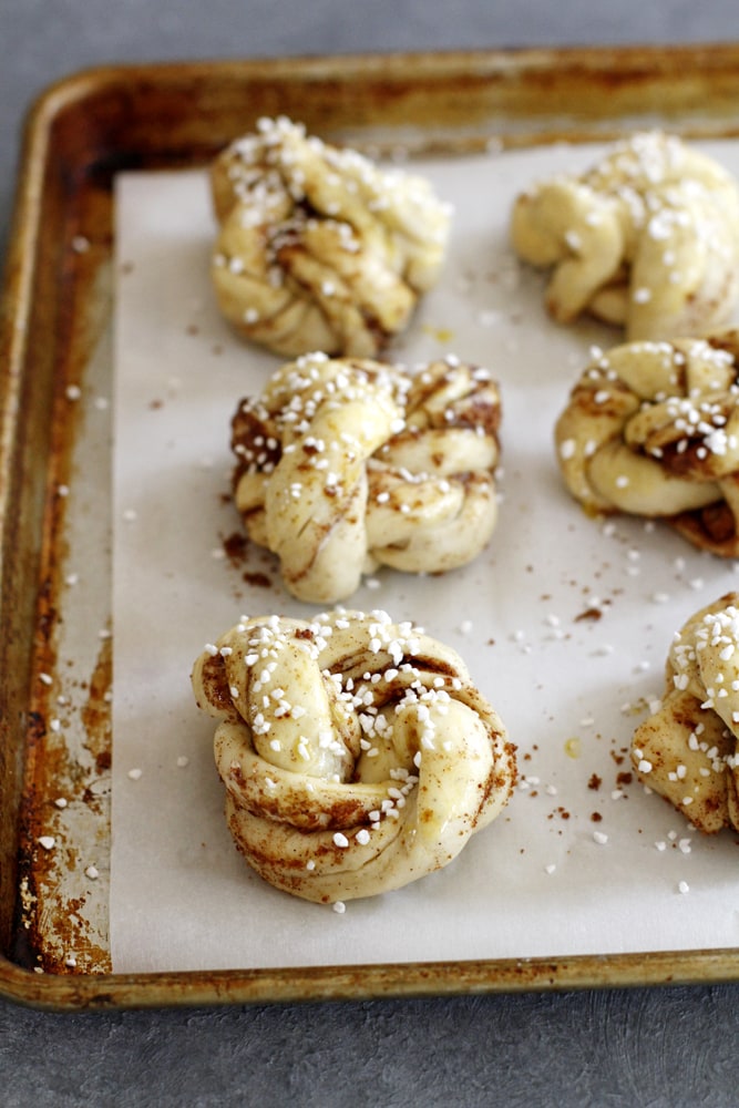 swedish cardamom buns on a baking sheet