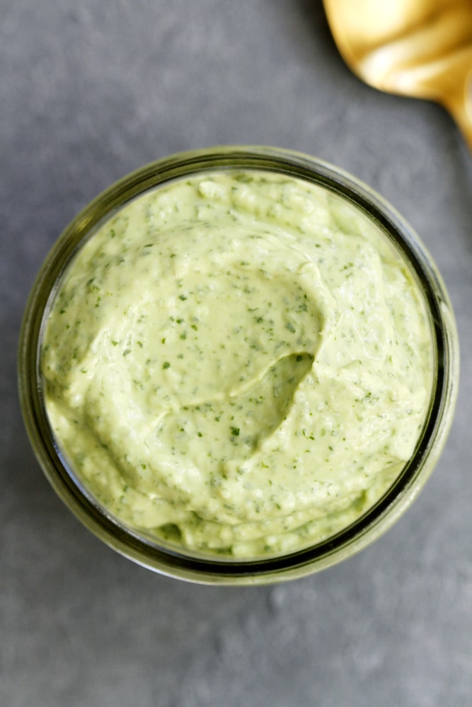 creamy avocado cilantro sauce in glass jar