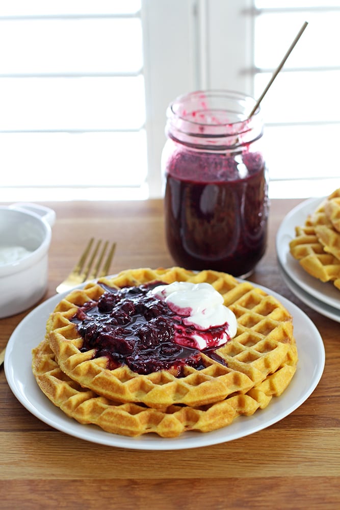 fluffy coconut flour waffles on plate with berry compote