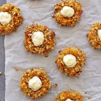 carrot cake thumbprint cookies on parchment paper
