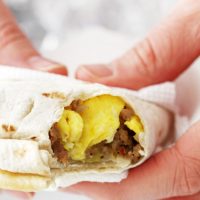 hands holding a freezer breakfast burrito