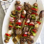 grilled steak mushroom kabobs on platter.
