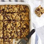 whole wheat oatmeal chocolate chip cookie bars in a baking dish.