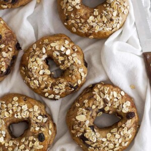 chocolate chip bagels arranged on white muslin cloth.