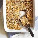 caramel coconut chocolate chip bars in baking dish.