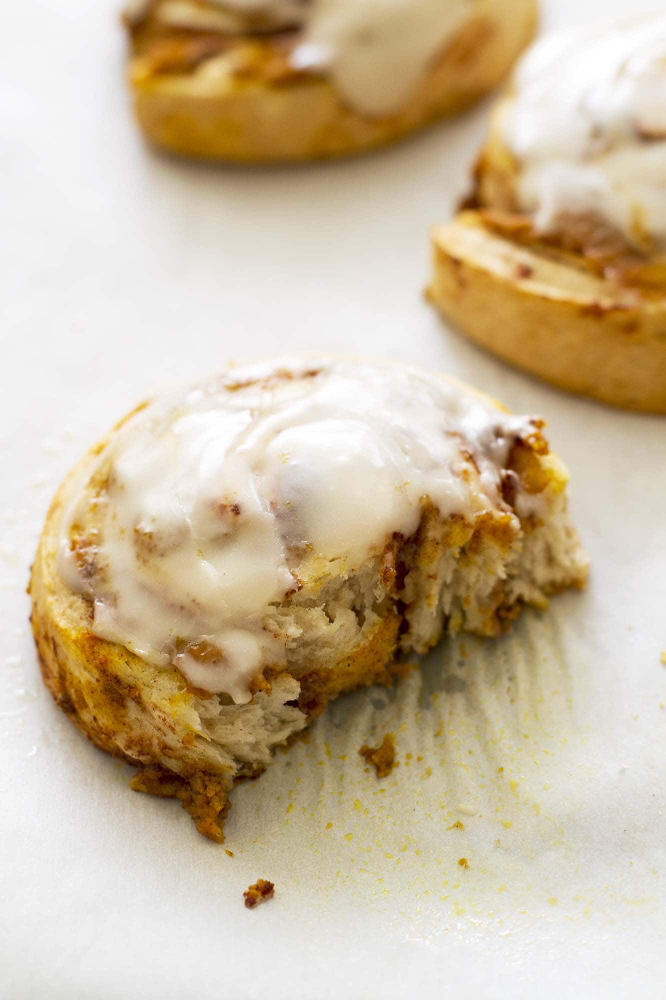 brown butter pumpkin cinnamon roll with bite taken