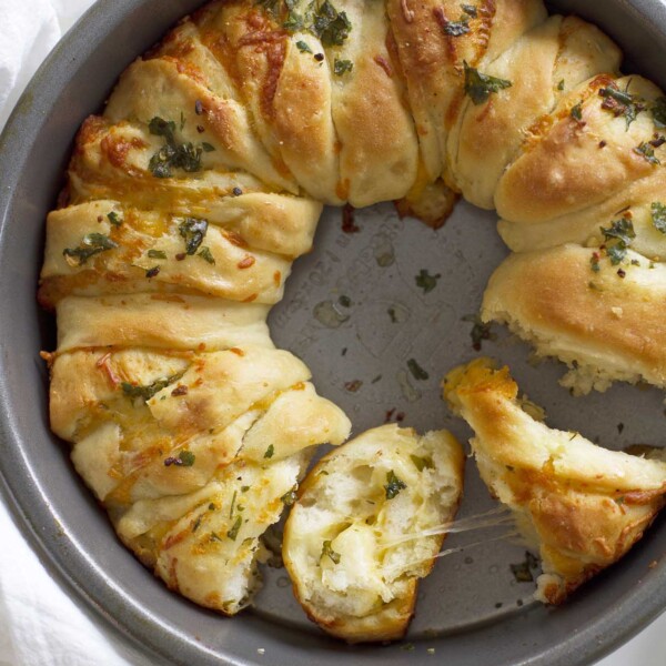 cheesy garlic herb pull apart bread in a baking pan.