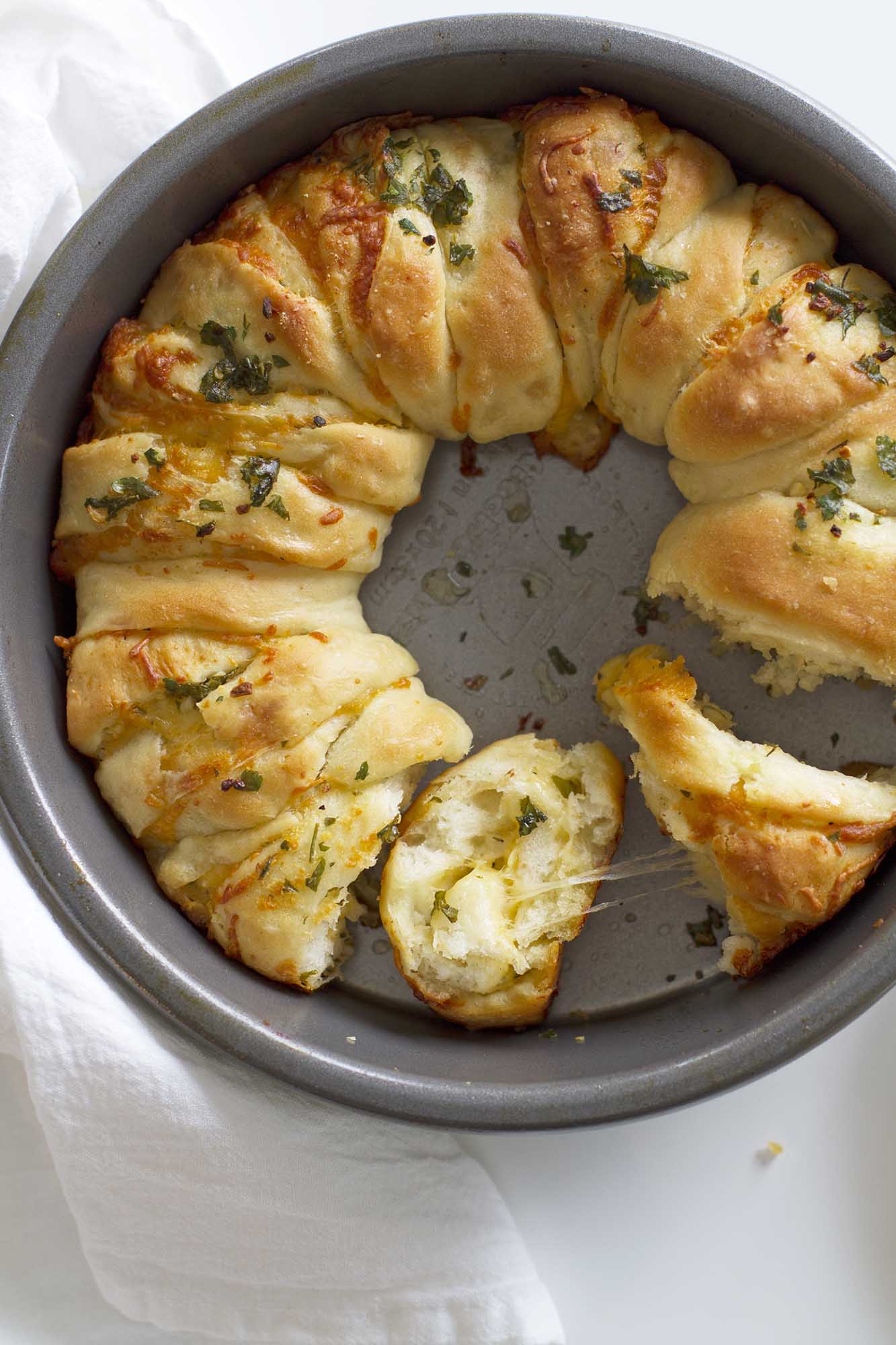 cheesy garlic herb pull apart bread in a baking pan
