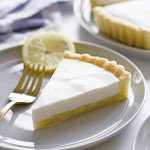 lemon buttermilk sugar cookie tart slice on plate.