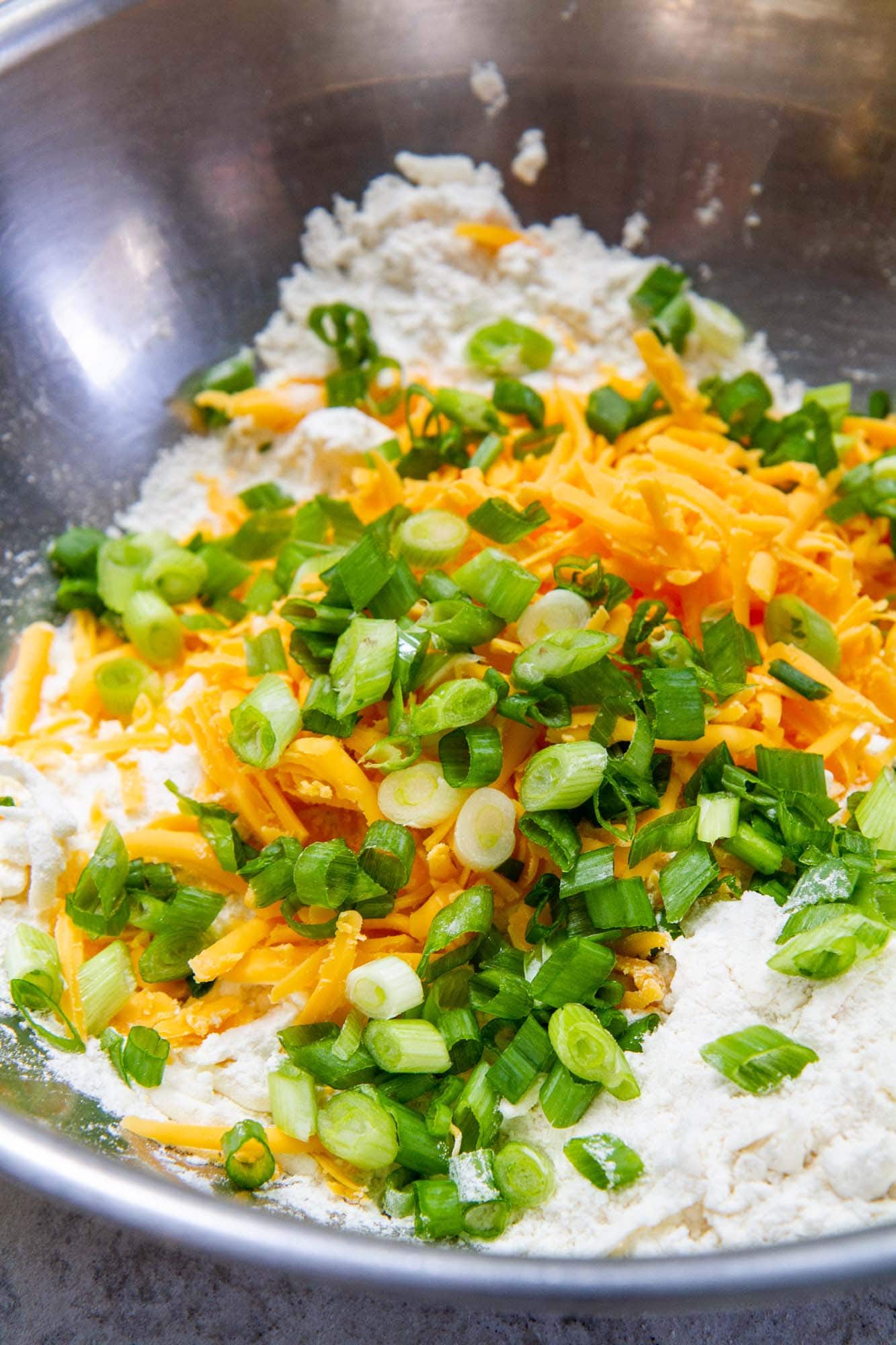 cheddar scallion biscuits ingredients in bowl