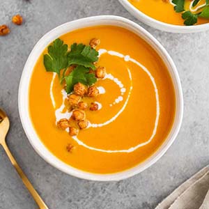 carrot ginger coconut soup in bowl.