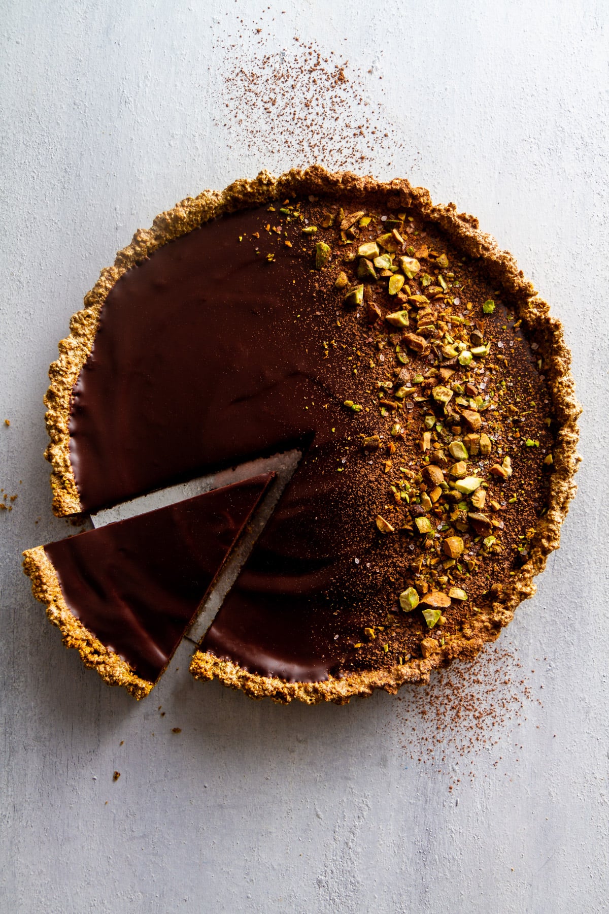 dark chocolate pistachio tart on a surface