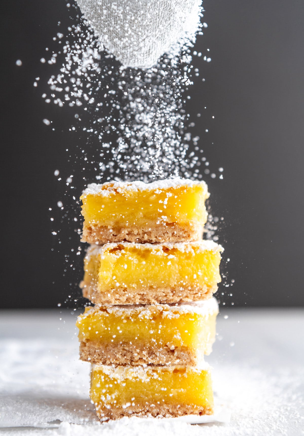 a stack of gluten free lemon bars dusted with powdered sugar