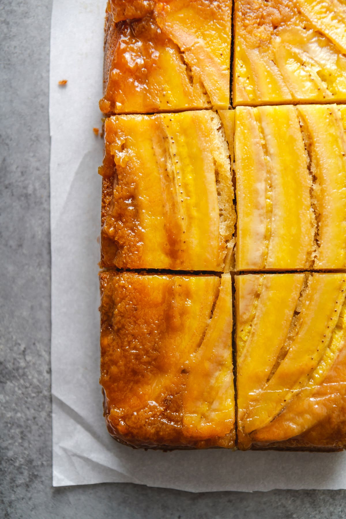 slices of bananas foster upside-down cake on parchment paper