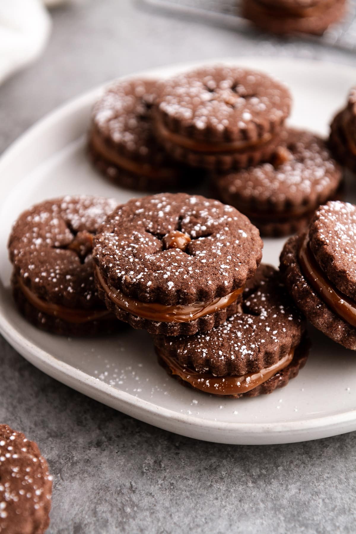 chocolate alfajores stacked on a plate