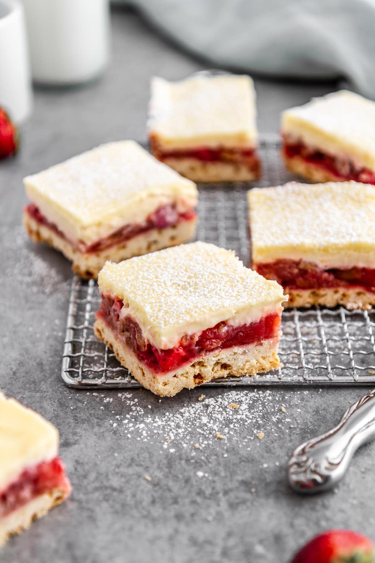 strawberry rhubarb cheesecake bars on a cooling rack