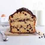 sliced cookie dough stuffed pound cake on a cooling rack with a knife next to it.